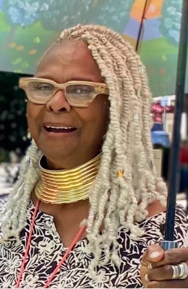 smiling woman with glasses and long braids
